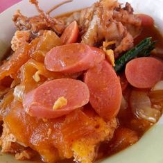 a white bowl filled with meat and vegetables