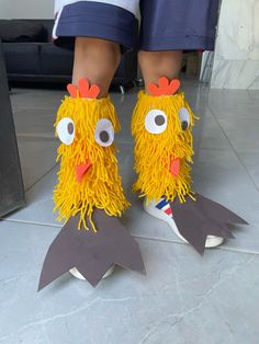 the legs and feet of a child wearing chicken shoes