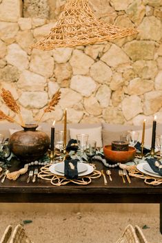 the table is set with plates and place settings