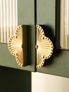 a close up of a door handle on a green cabinet