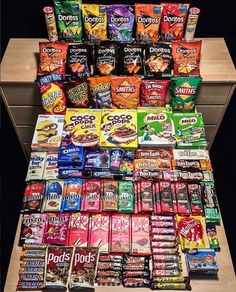 a display case filled with lots of different types of snacks and candy bar wrappers