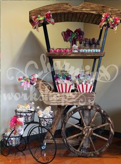 an old fashioned cart with cupcakes and candy