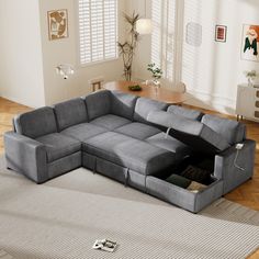 a living room with a sectional couch and storage compartment in the middle, on top of a rug