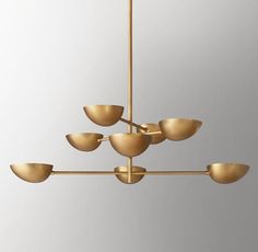 a gold chandelier with five lights hanging from it