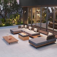 an outdoor living area with couches and tables