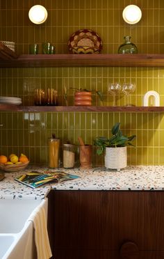 the kitchen counter is covered with dishes and cups