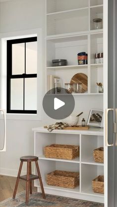 a white room with shelves and baskets on the floor