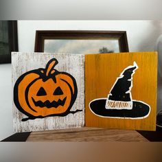 two wooden blocks decorated with pumpkins and witches hats