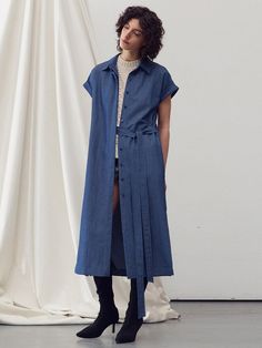 This product is a belted midi shirt dress that offers a versatile and contemporary take on the classic shirt dress. The piece features a pointed collar and a front button closure that runs the length of the dress, allowing for a customizable fit. The addition of a belt emphasizes the waist, while the midi length strikes an elegant balance between casual and formal. - The dress's side slits provide freedom of movement and a touch of allure.- Its roll-up sleeve design adds a casual, effortless look, suitable for different seasons.- The lightweight fabric ensures comfort and breathability throughout the day.- This midi shirt dress can be dressed up with heels or down with flats, making it a staple for any occasion. Classic Belted Shirt Dress For Semi-formal Occasions, Fitted Button-up Belted Dress For Daywear, Fitted Belted Button-up Shirt Dress, Collared Single Breasted Shirt Dress For Work, Fitted Belted Shirt Dress For Work, Midi Length Belted Dress With Buttons For Workwear, Fitted Button-up Belted Shirt Dress, Spring Knee-length Belted Dress With Buttons, Belted Fitted Shirt Dress With Spread Collar