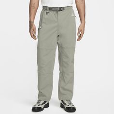 From tackling tough, mountainous terrain to taking a morning stroll through town, these versatile hiking pants from ACG are made for all your daily adventures. The relaxed, straight-leg fit is designed to hit at the ankle for casual, daily wear. Their lightweight, stretchy build and UV-blocking fabric make them an ideal building block for your outfit. Mens Travel Clothes, Webbing Belt, Quick Release Buckle, Nike Acg, Hiking Pants, Wet Weather, Grey Leggings, Building Block, Nike Pants