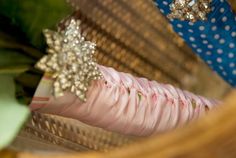 a close up of a person's shoes in a hammock with flowers on it