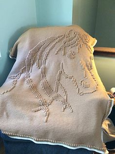 a blanket that is sitting on top of a chair