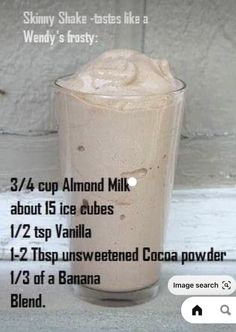 a tall glass filled with ice cream on top of a table