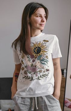 "MY GIRL, YOUR TIME WILL COME (Unisex tee): Designed and handmade in Phoenix. This blooming crystal goddess, surrounded by blooming flowers and crystals, was inspired by a dream I had of my Grandmother (Nona) telling me: \"My girl, your time will come.\" It is a very special design, made with love. ★CURRENT PROMOTIONS! ★ >Keep an eye out for our 20% off flash sale! We run it randomly, so be sure to keep checking back! >When sale is running, add items to your cart and the discount will auto Fairy Grunge Crew Neck T-shirt For Festival, Bohemian Short Sleeve T-shirt With Plant Print, Plant Goddess, Witchy Goddess, Your Time Will Come, Flowers And Crystals, Crystal Goddess, Run It, Floral Tee