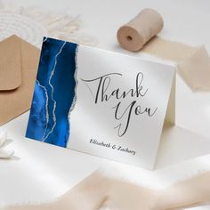 a thank card with the words thank you on it next to some crafting supplies