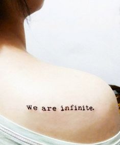 the back of a woman's shoulder with an inscription on it that says, we are infinite