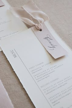 the wedding stationery is laid out on top of each other