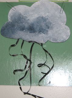 a paper cut out of a cloud with wires attached to the top and bottom of it