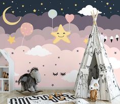 a child's room with a teepee tent, stars and clouds on the wall