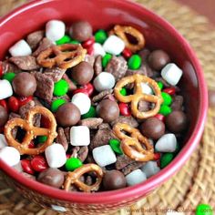 a red bowl filled with cereal and pretzels