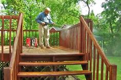 a man standing on top of a wooden deck