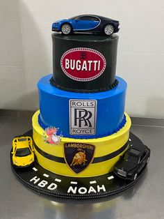 a three tiered cake decorated with cars and the name bugatti on it