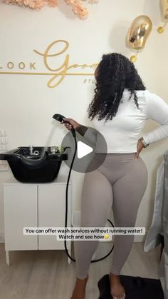 a woman in tights is holding a hair dryer