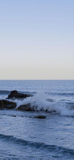 waves crashing on rocks in the ocean