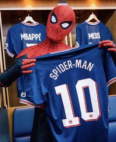 the spider man jersey is being held by two men