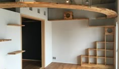 an empty room with wooden shelves and stairs