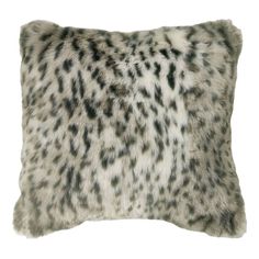 a white and black animal print pillow on a white background