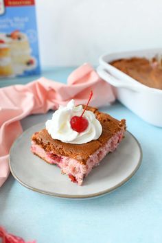 a piece of cake sitting on top of a plate next to a box of frosting