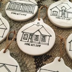 six ceramic ornaments with houses drawn on them