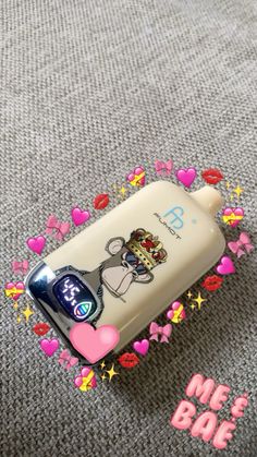 a cell phone is laying on the ground with hearts around it and an image of a cartoon character