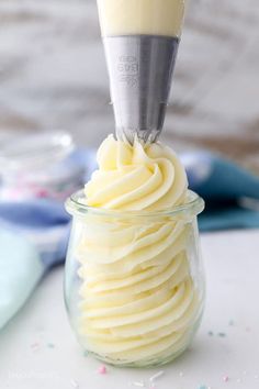 a small glass jar filled with whipped cream