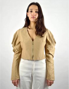 Made in FranceProduct description :- Camel short fitted shirt,- Zipped on the front,- Darts on the back and chest,- V-neckline and long, wide sleeves draped over the shoulder.The Zopa Shirt will conquer your daily life thanks to its short fitted cut that highlights the waist and structures the silhouette. The draped detail of the shoulders gives the whole a sophisticated look, without overloading the outfit. Made from a thick cotton canvas from fine rolls of fabric from a major luxury brand, the Camel Shorts, Fitted Shirt, Wide Sleeves, Daily Life, Workout Shirts, Luxury Branding, Highlights, Long Sleeve Blouse, Product Description