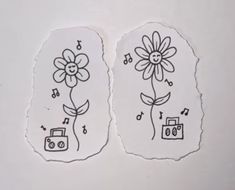 two stickers with flowers and music notes on them, one has a camera in it