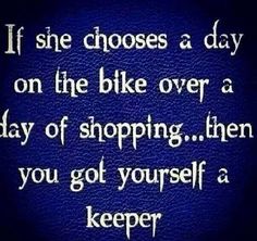 a blue background with the words if she chooses a day on the bike over a ray of shopping then you got yourself a keeper