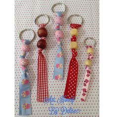 four key chains with different designs on them