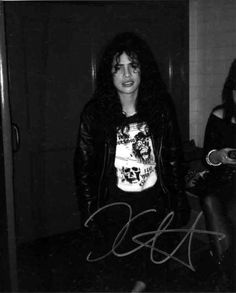 an autographed black and white photo of a woman in a room with two other women