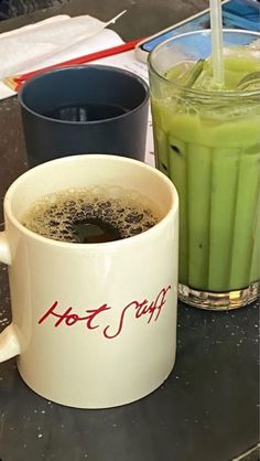 there is a cup of green tea next to a drink