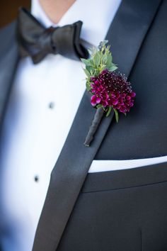 a man in a tuxedo with a boutonniere on his lapel