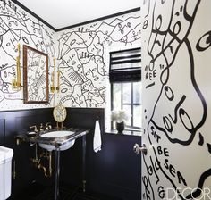 a black and white bathroom with gold accents