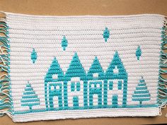 a crocheted afghan with the word arctic written in white and blue on it