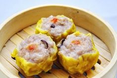 three small food items in a wooden bowl