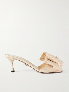 MACH & MACH's 'Cadeau' mules have such a summery feel, all thanks to their woven raffia construction. Designed with round toes, they're adorned with an oversized double-bow at the straps and rest on 65mm heels that offer comfortable lift. Slip yours on with jeans and sundresses alike. Chic Straw Mules For Spring, Chic Spring Heels Made Of Straw, Chic Straw Heels For Spring, Chic Natural Mules For Spring, Elegant Straw Heels For Vacation, Chic Natural Color Spring Mules, Chic Beige Straw Mules, Elegant Beige Straw Sandals, Feminine Mules For Formal Summer Occasions