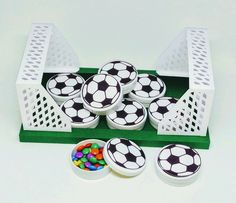 a green tray filled with soccer balls and candy