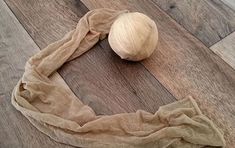 an onion on the floor next to a piece of cloth that has been folded around it