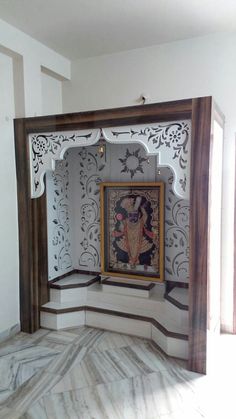 an ornately decorated room with a painting on the wall and wooden frame around it