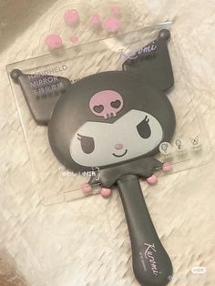 a close up of a hair dryer shaped like a cat with skull on it